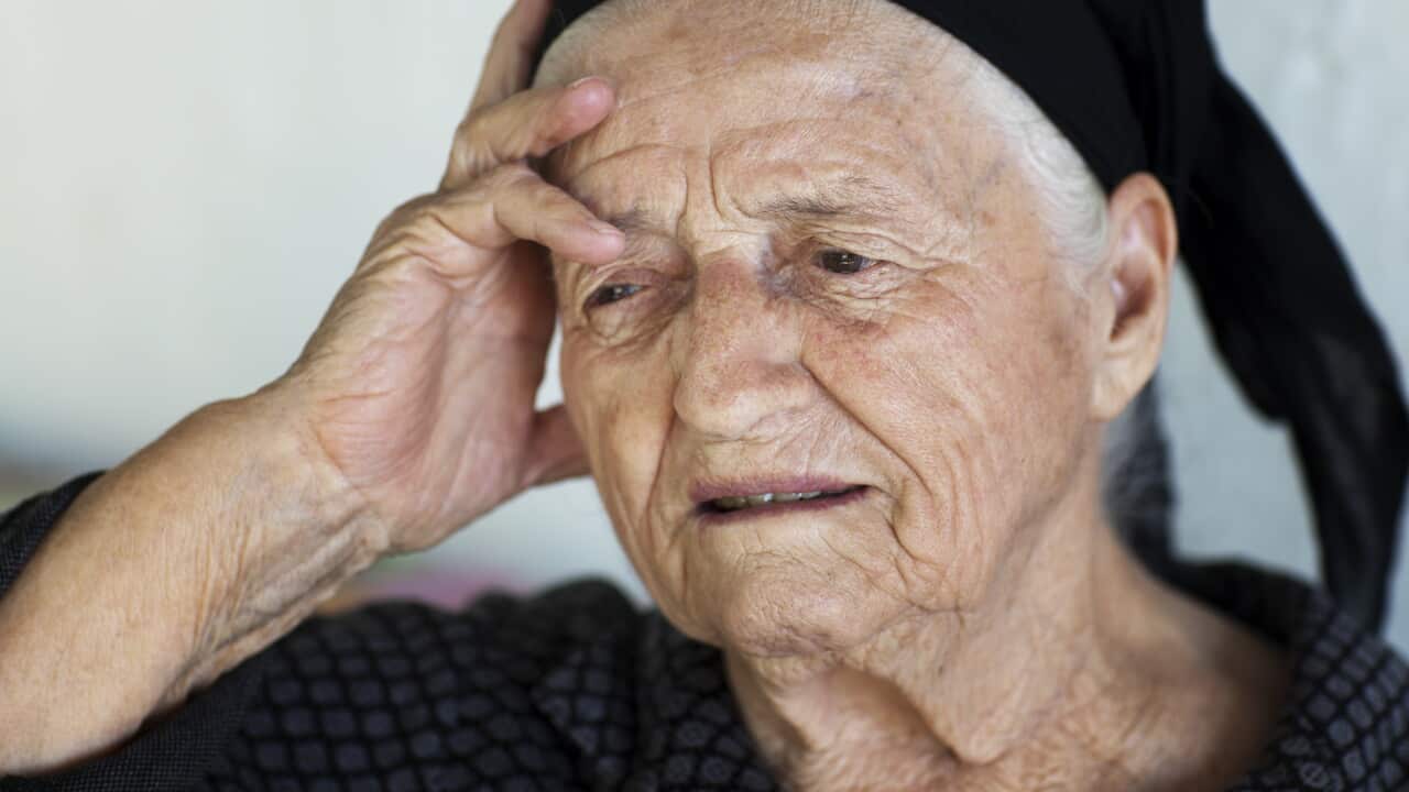 Elderly woman displaying contemplation and introspection indoors
