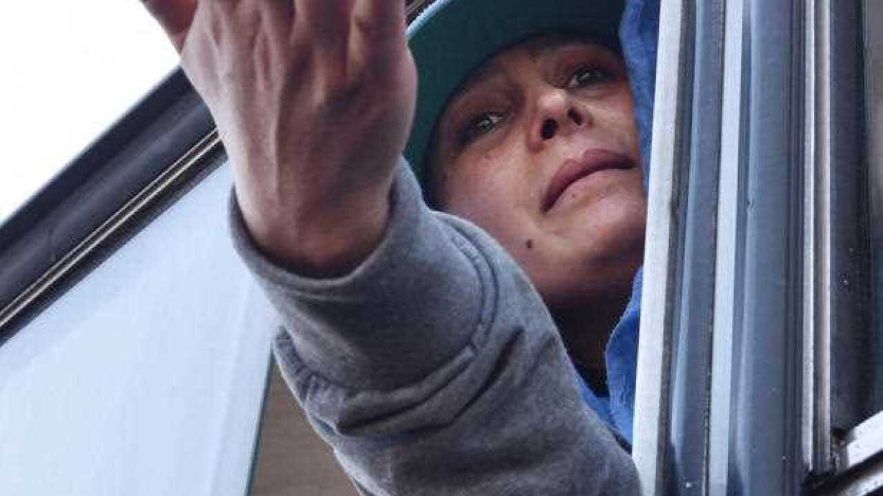 A migrant woman cries from bus bound for Hungary in Tovarnik, Croatia