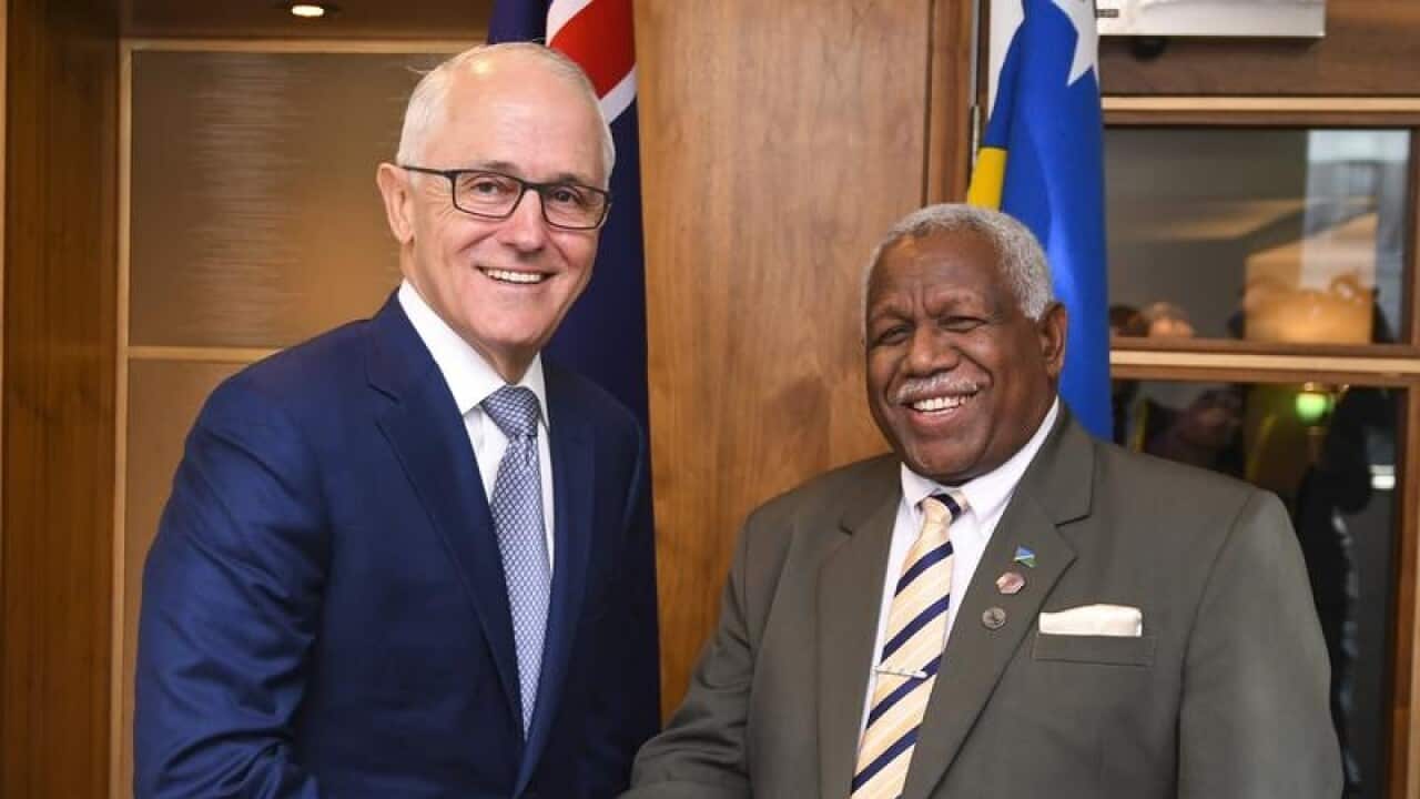Malcolm Turnbull and Solomons PM Rick Houenipwela shake hands.