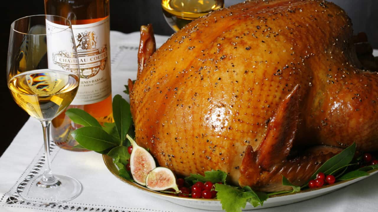 A glazed turkey with glasses of wine