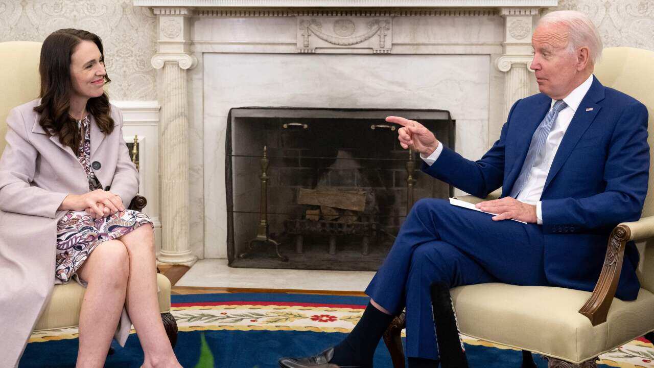Two people sitting on chairs and talking