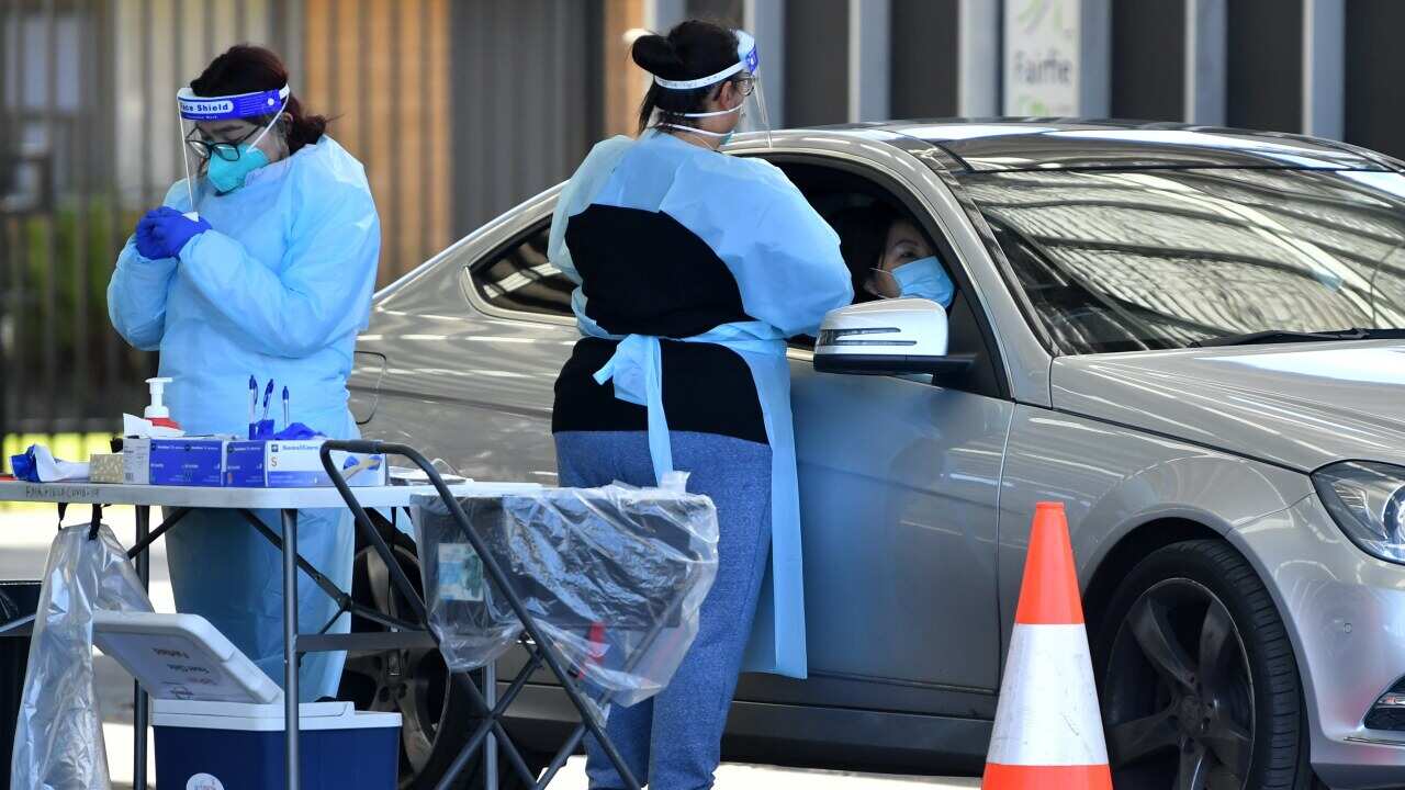 Members of the public are tested at a pop up COVID clinic at Fairfield in Sydney.