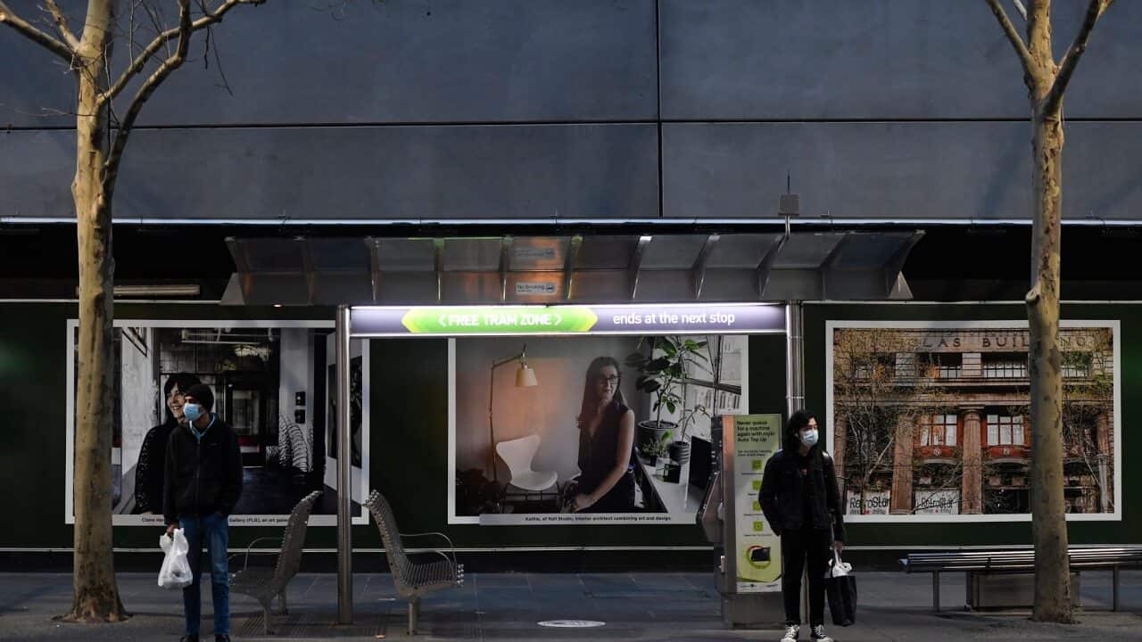 People wait for a tram in Melbourne on 2 August 2020.