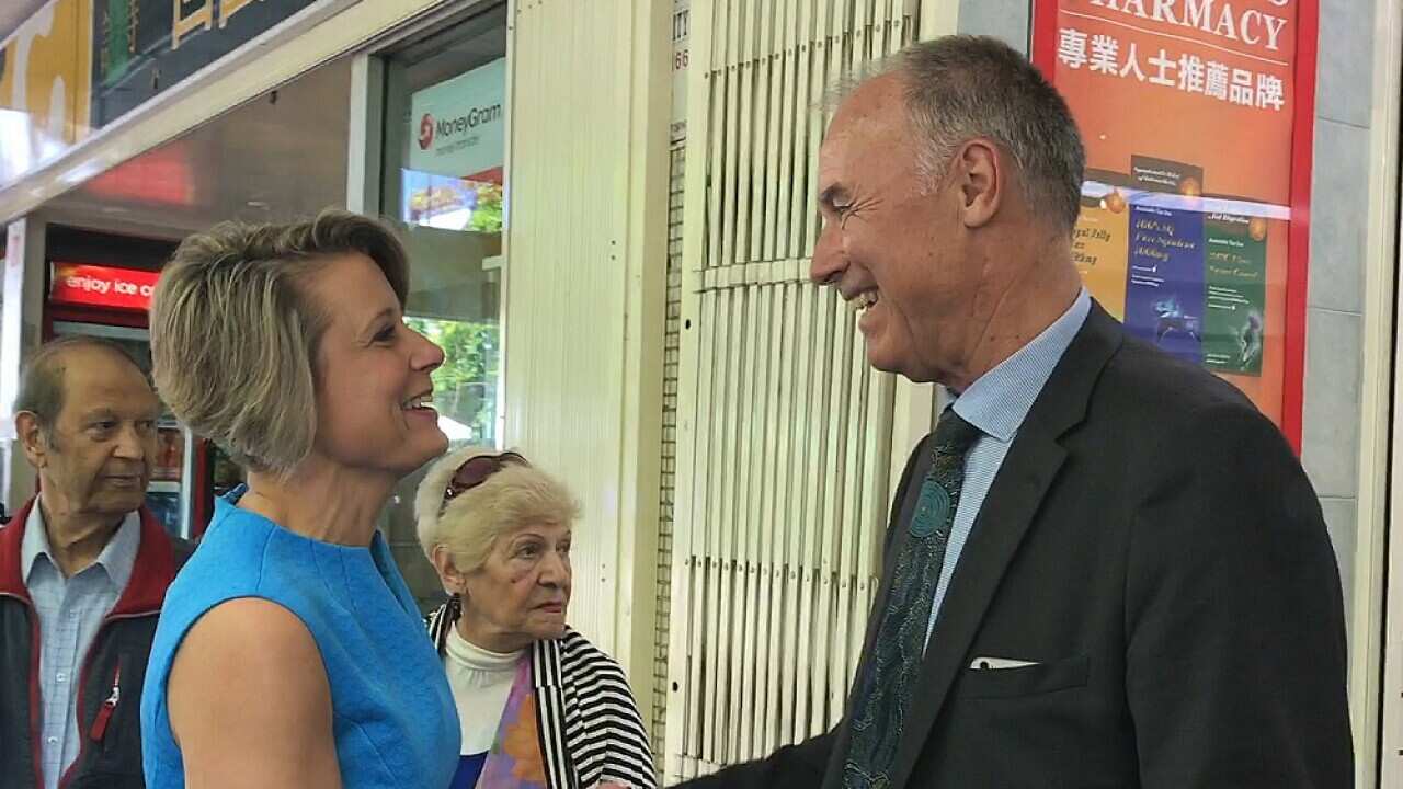 Kristina Keneally (left) runs into former member for Bennelong John Alexander during a visit to Eastwood Mall in Sydney, Wednesday, November 15, 2017.