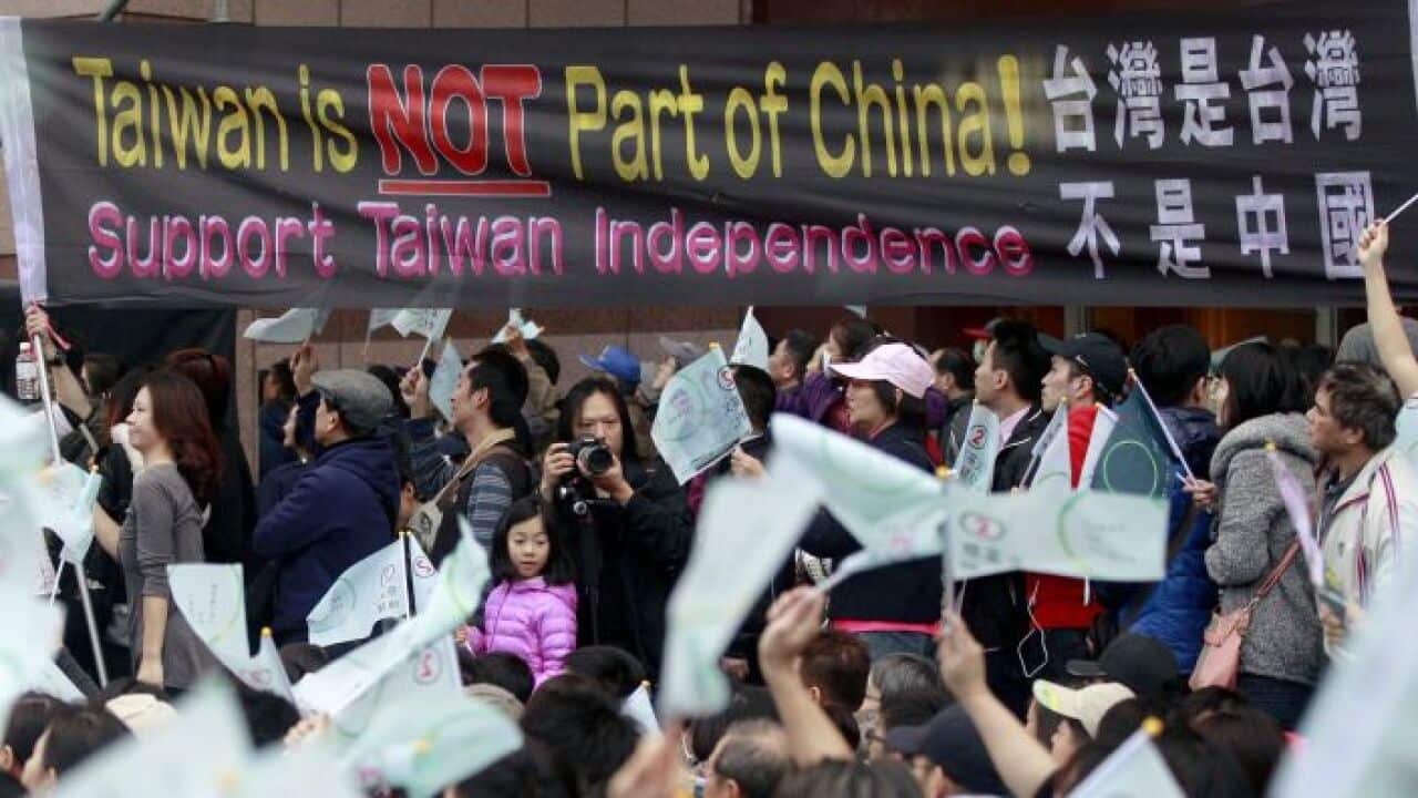 Supporters of Taiwan's Democratic Progressive Party (DPP) cheer under a banner in Taipei, January 16, 2016