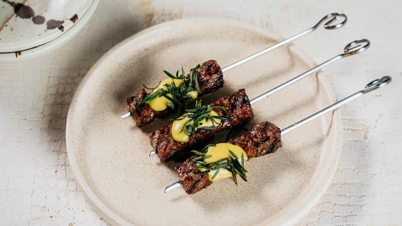 Beef skewer, mustard dressing and fried rosemary
