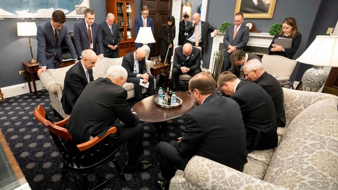 Mike Pence prays during a meeting with the US Coronavirus Taskforce.