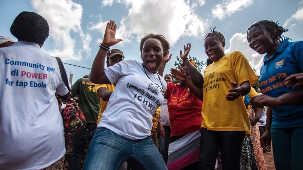 Women celebrate as their country is declared Ebola free in the city of Freetown Sierra Leone