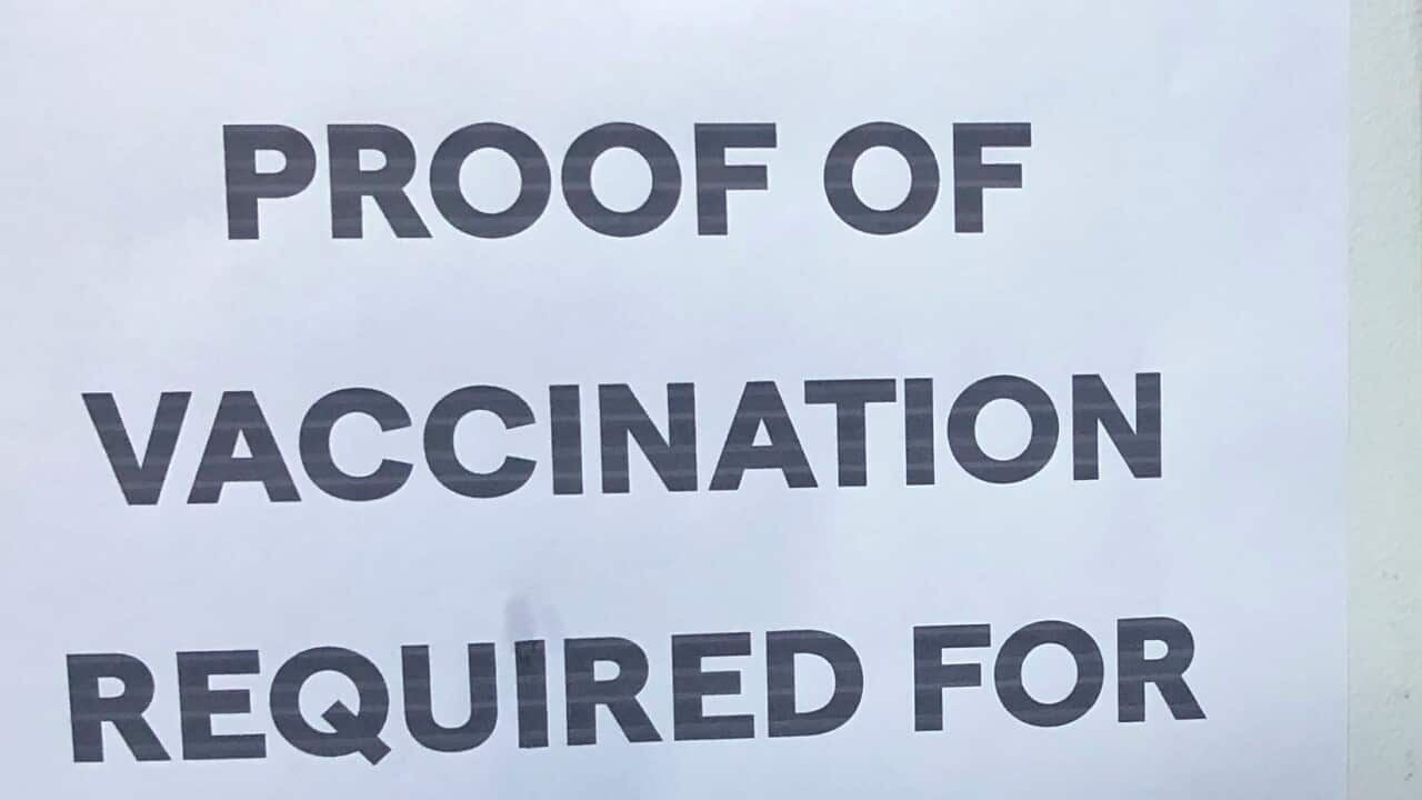 A proof of vaccination sign posted.
