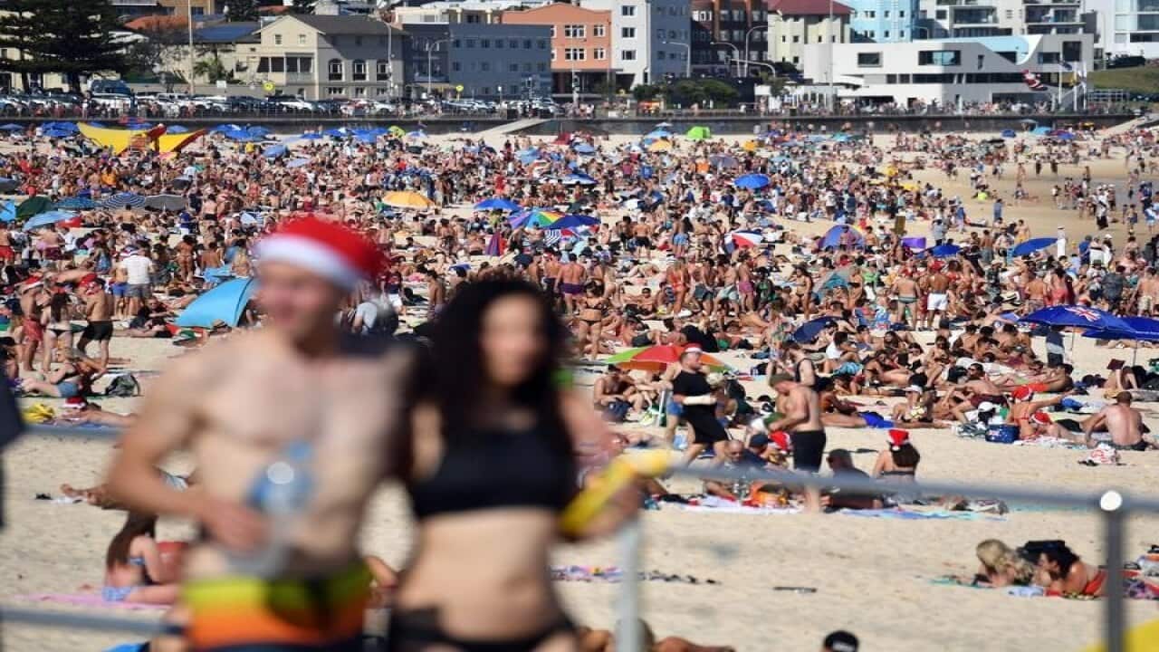 Beachgoers celebrate Christmas at Bondi Beach in Sydney