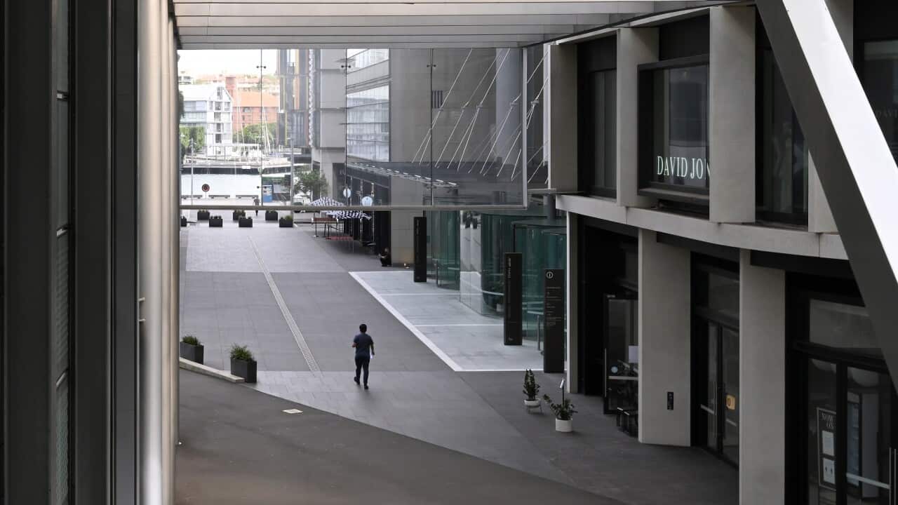 A man walks through the usually busy Barangaroo shopping and business area in Sydney