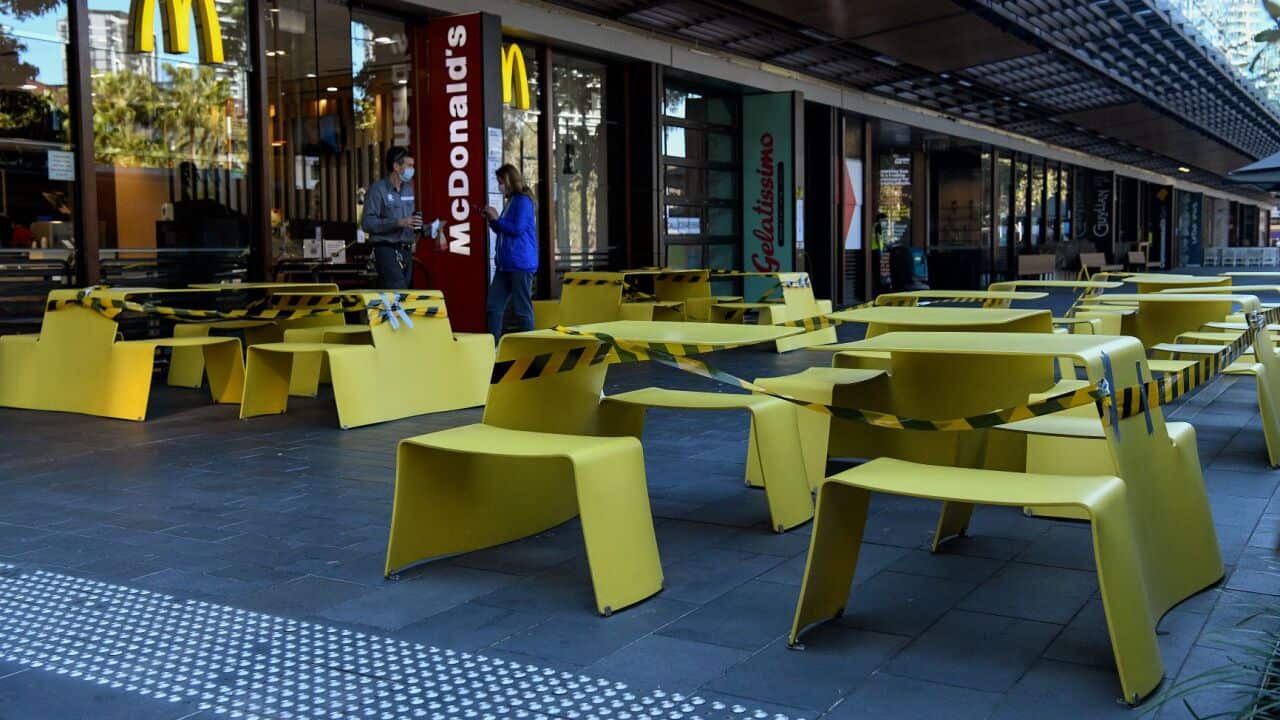Chairs and tables are roped off to stop people from gathering at a fast food outlet in Sydney, Thursday, August 26, 2021.
