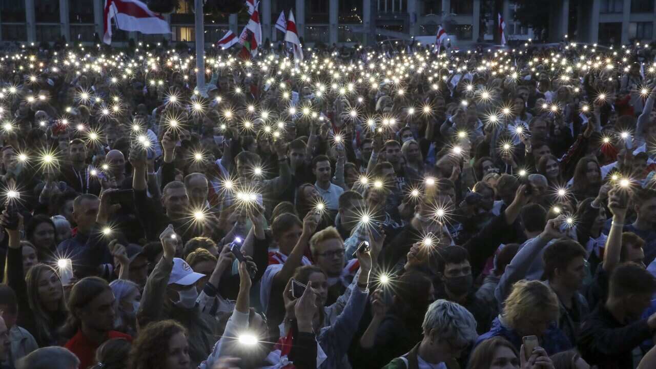People use their mobile phone torches during an opposition rally in Independence Square in Minsk.