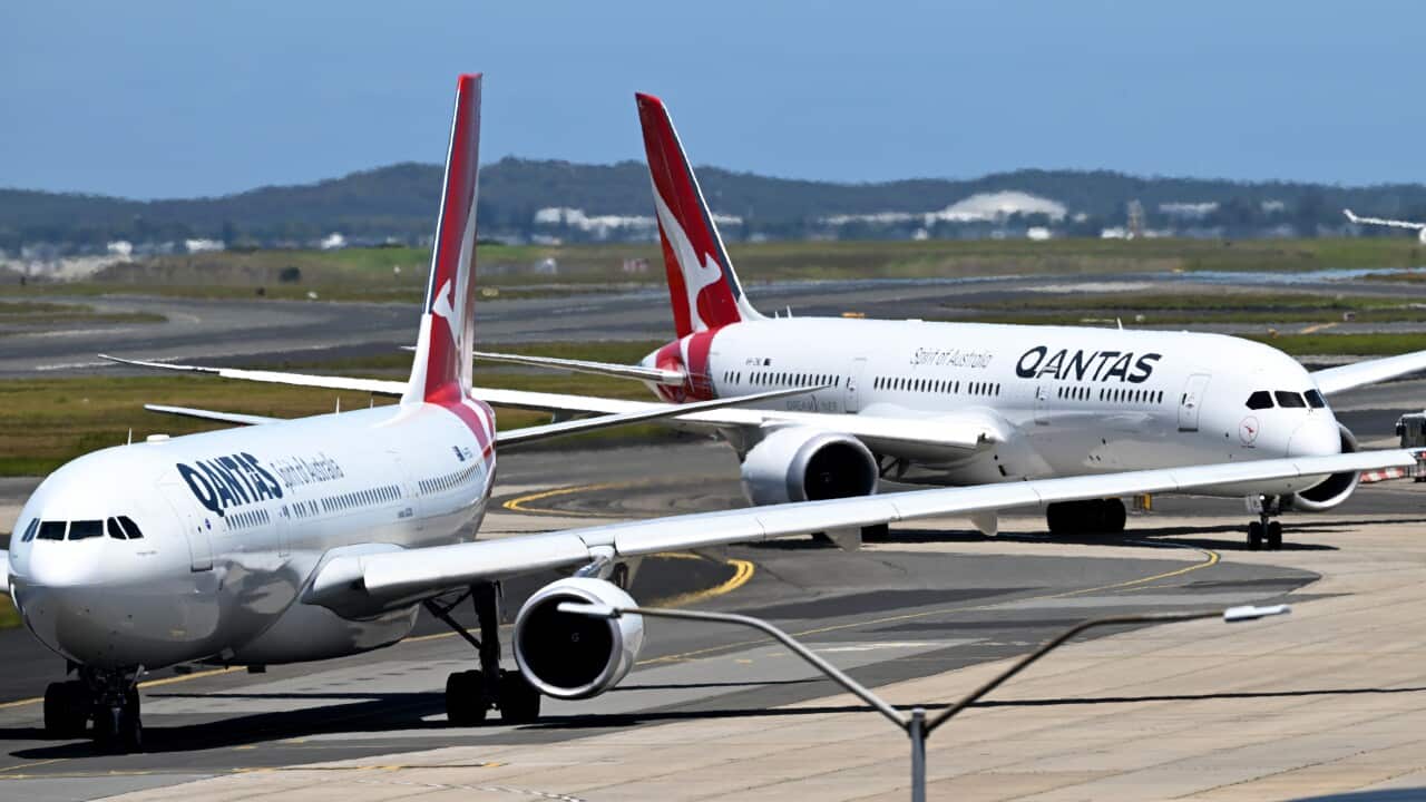 Two Qantas planes at an airport