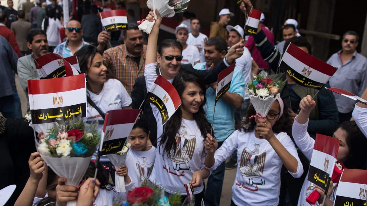 Egyptian children and national flags during the first day of elections.