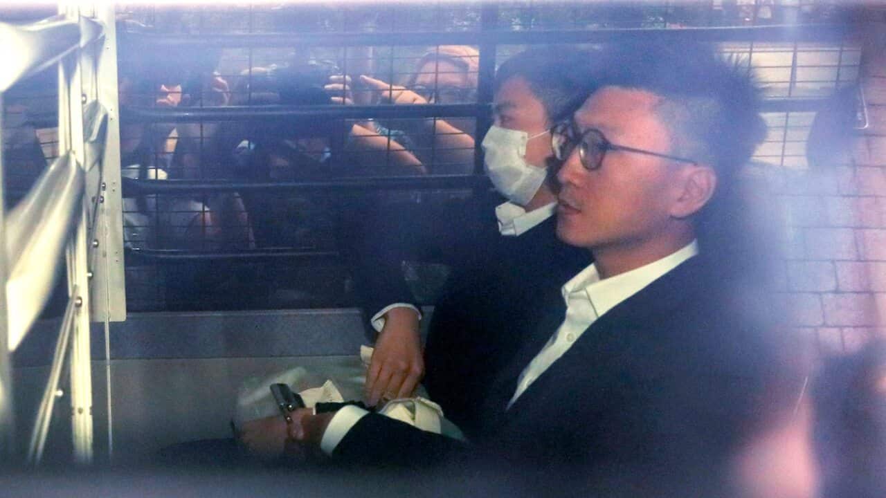 Hong Kong Jailed activist Edward Leung, right, is escorted by Correctional Services officers in a prison van as he arrives high court for his sentence appeal.