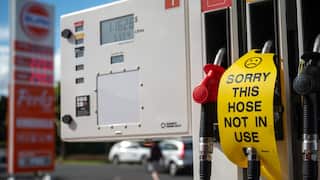 A sign saying 'sorry this hose not in use' on a petrol bowser at a service station