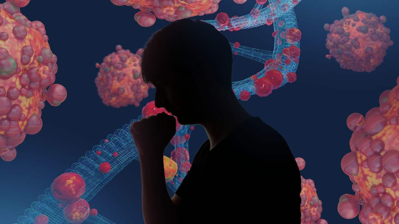A silhouette of a person coughing, with computer-generated imagery of bacteria in the background.