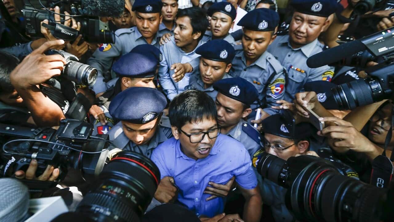 Reuters' journalists Wa Lone (centre front) and Kyaw Soe Oo (centre back) are escorted by police as they leave the court after their first trial.