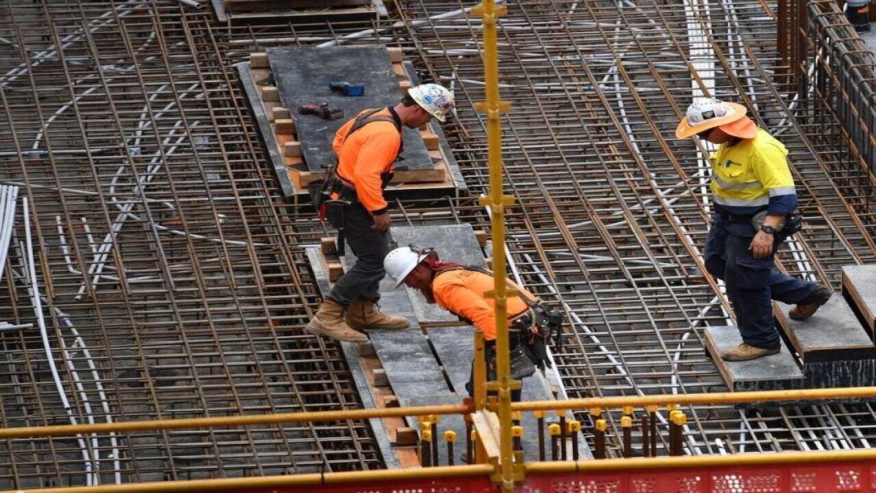 Construction workers are seen on a building site.