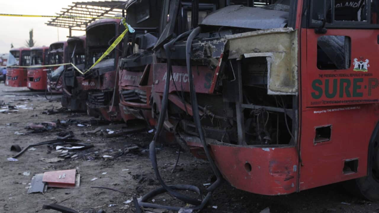 Damaged buses at the scene of an explosion at a bus station