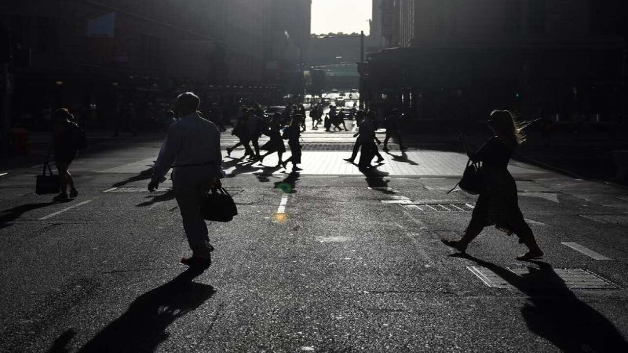 Office workers are seen arriving to work in the Sydney CBD.
