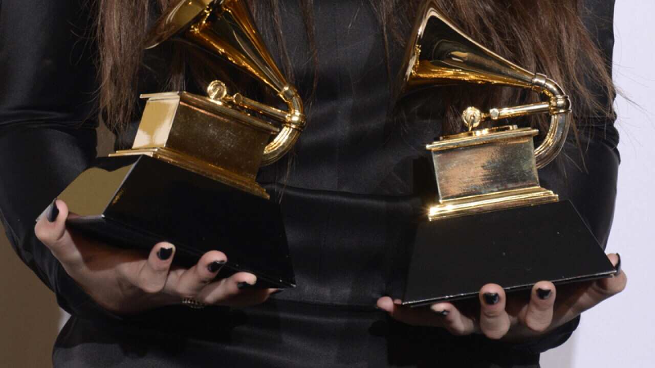 New Zealand singer Lorde poses with her Grammy Awards