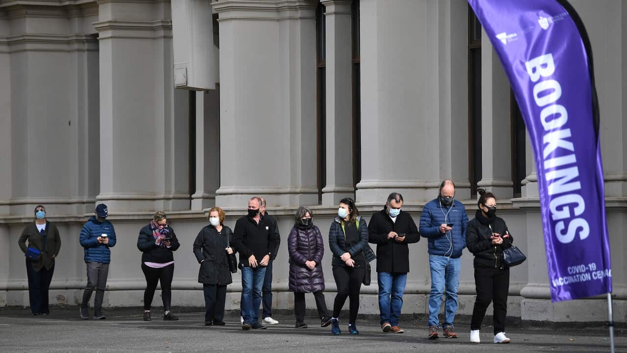 People are seen in a line outside the Melbourne Exhibition Centre coronavirus vaccination hub as a 'Free Melbourne' anti-lockdown protest is expected to take place in Melbourne, Saturday, June 5, 2021. (AAP Image/James Ross) NO ARCHIVING