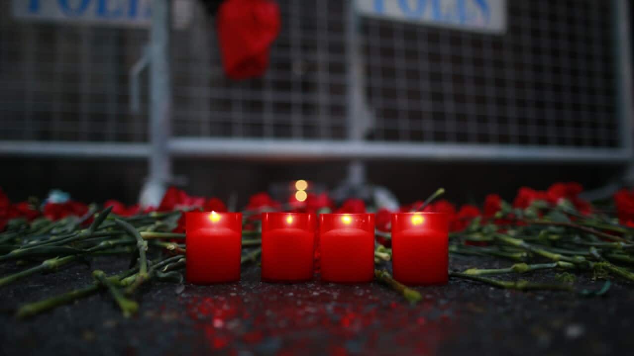 Candles are lit for the victims outside a nightclub