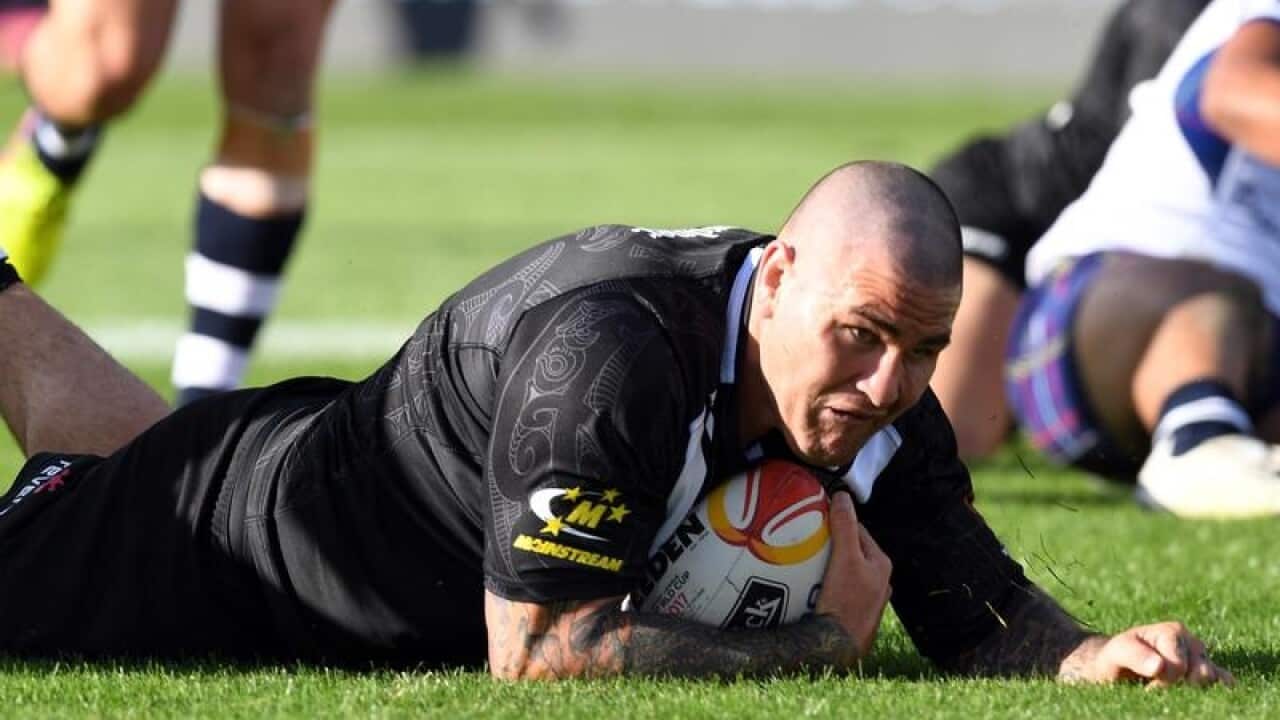 Russell Packer of New Zealand scores a try against Scotland.