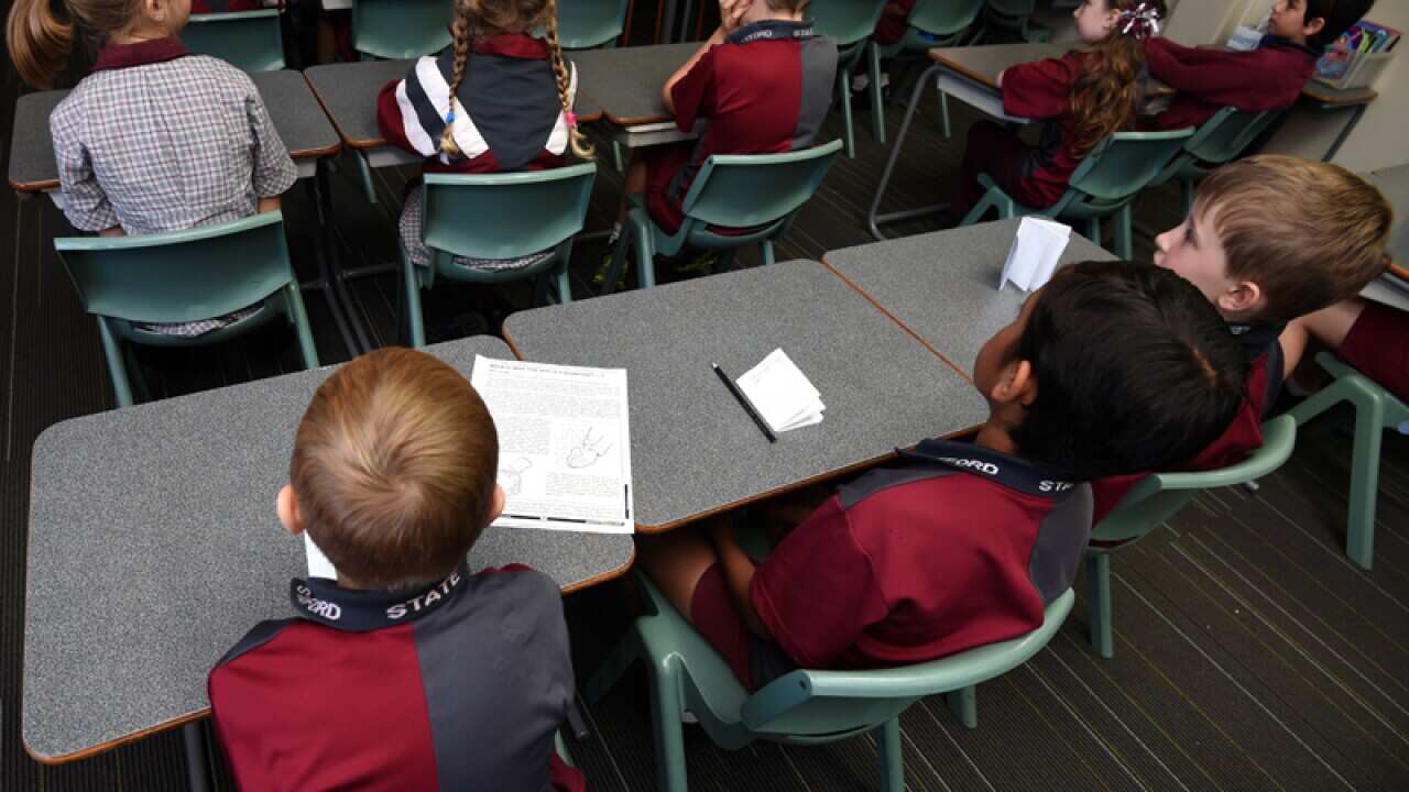 Children sit in a classroom