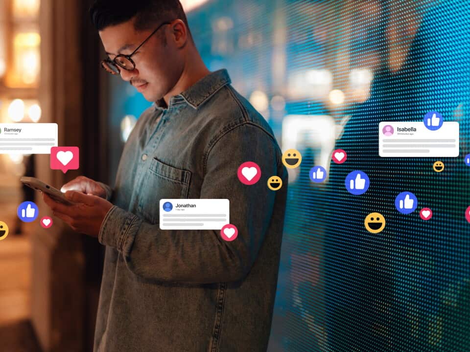 Young Asian man connecting with social media network with smartphone