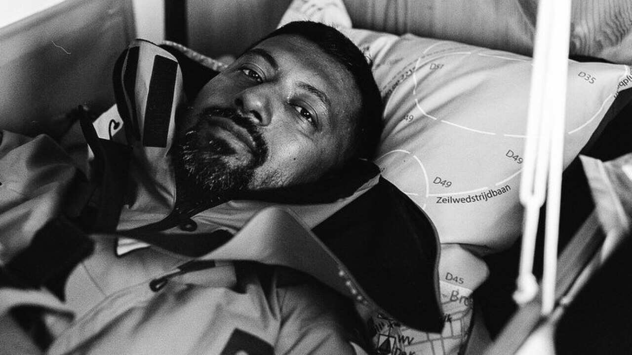 Indian solo yachtsman Abhilash Tomy lying in his bunk aboard his 10-metre vessel Thuriya
