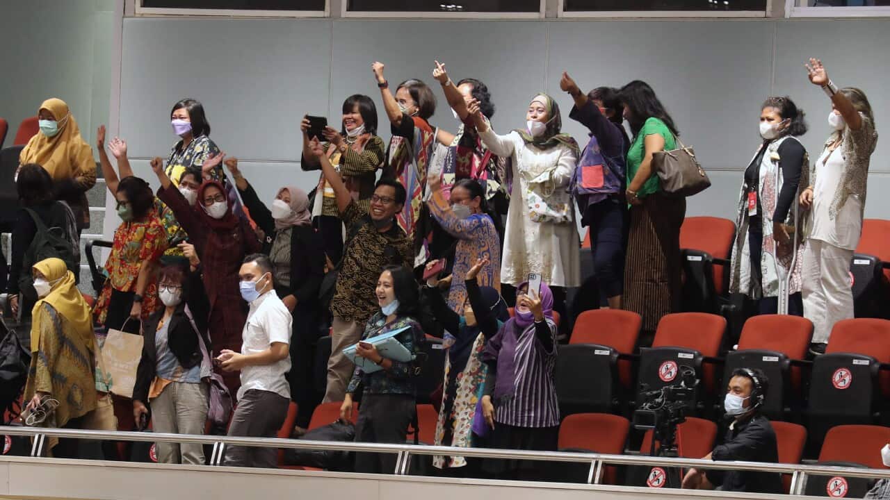 Indonesian activists are seen raising their fists.