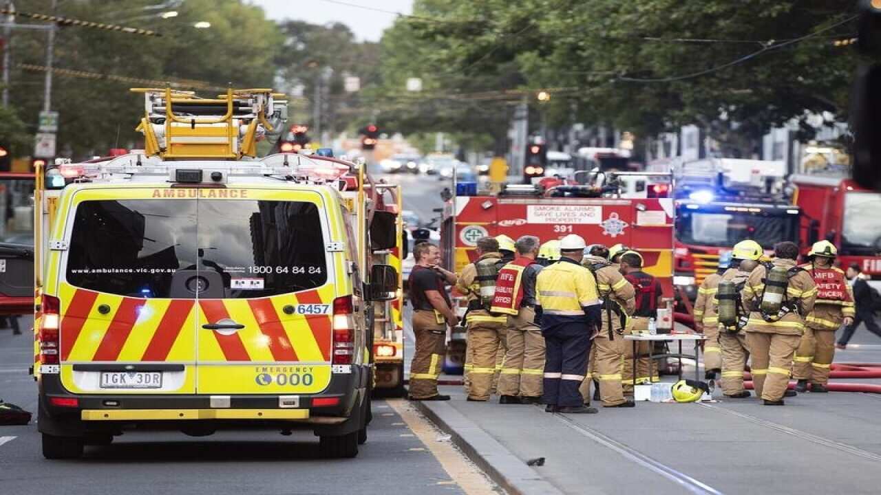 Firefighters are seen at the scene of an apartment building fire