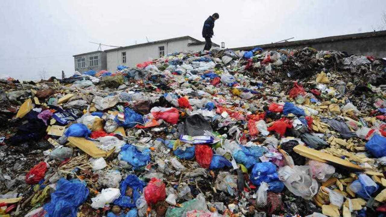A boy looks for toys on a garbage dump site near a village in Hefei, in central China's Anhui province.