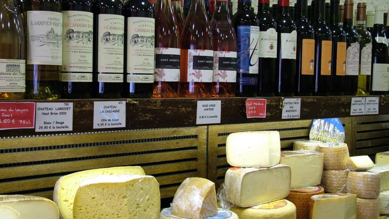 Some of the 400 varieties of cheese and shelves ofwine in a cheese shop in Rue Cler, Paris.