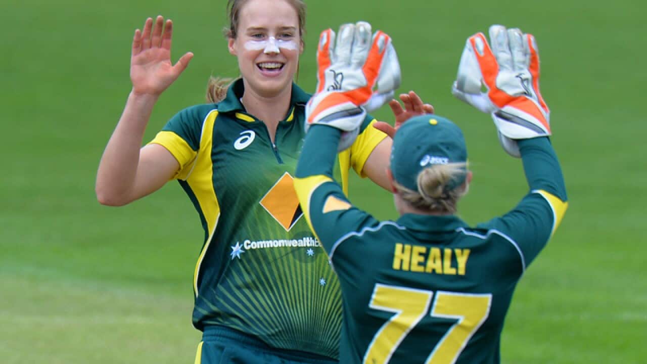 Australia's Ellyse Perry (L) is congratulated after claiming a wicket