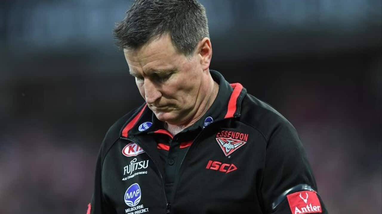 Bombers head coach John Worsfold walks off the pitch.