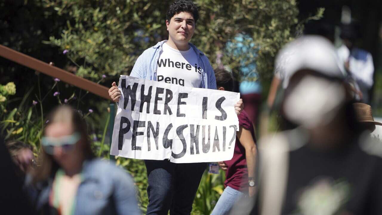 Protester, Drew Pavlou, holds a sign and wearing a t-shirt reading "where is Peng Shuai" on day twelve of the 2022 Wimbledon Championships