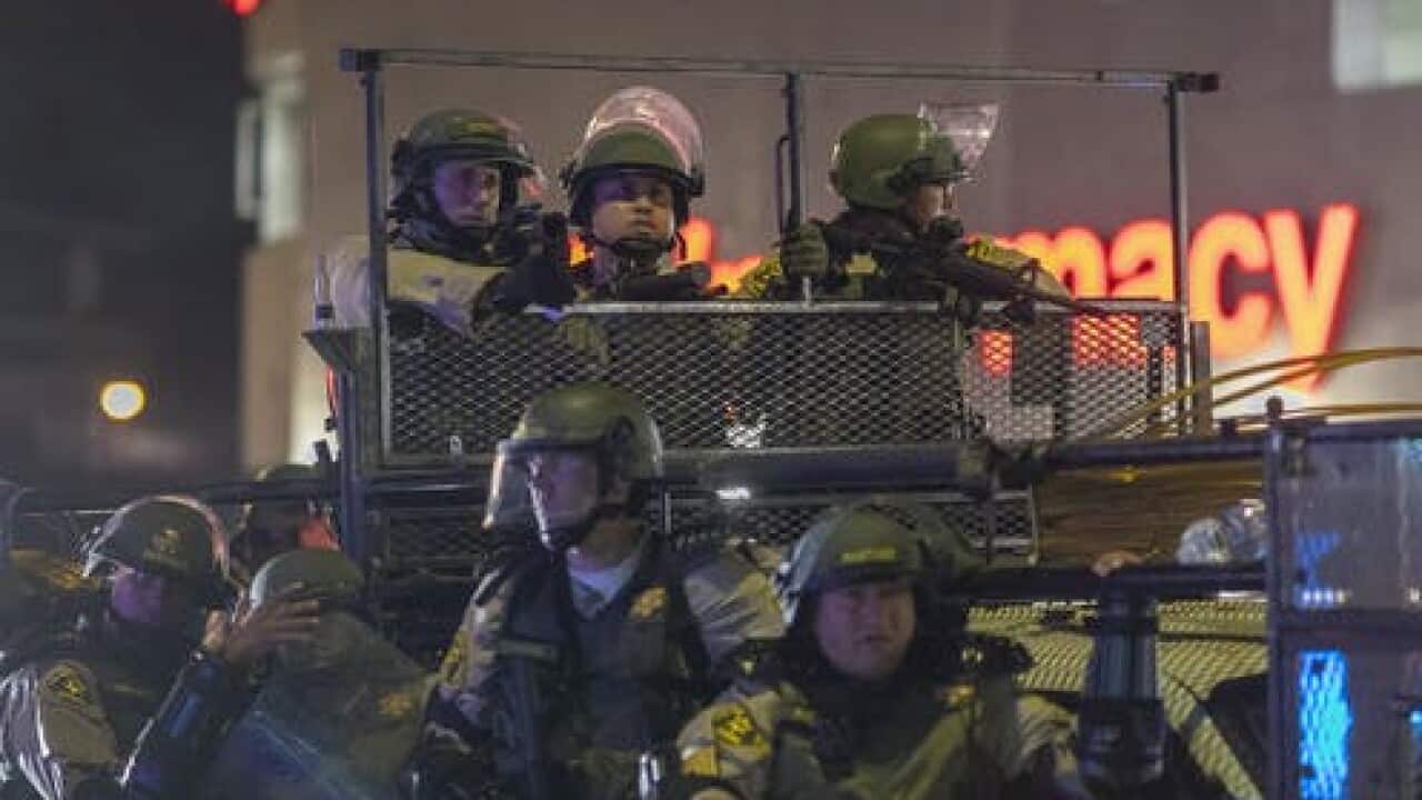 Sheriffs deputies in riot gear move in on protesters in Los Angeles, California.