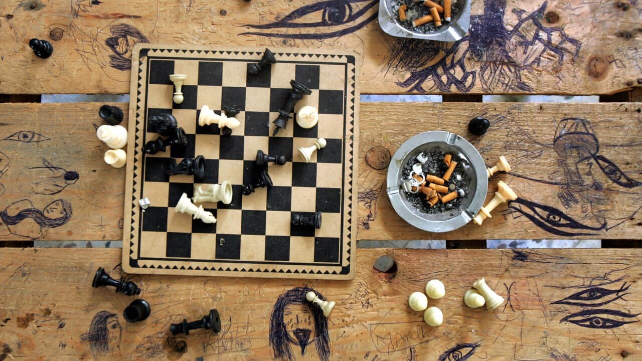 a chess board and unemptied ashtrays are seen in an abandoned house in the near-deserted and heavily-bombed village of Yaroun in southern Lebanon