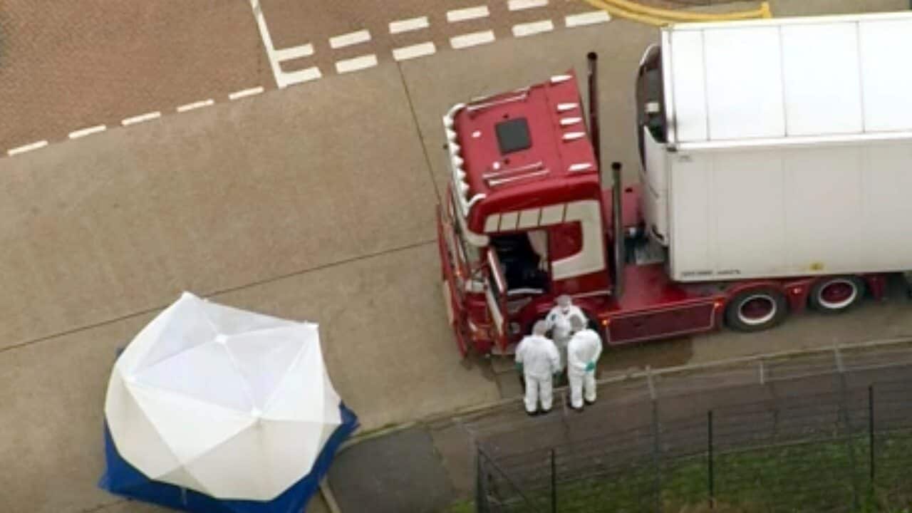 An aerial view as police forensic officers attend the scene after a truck was found to contain a large number of dead bodies, in Thurrock, South England.