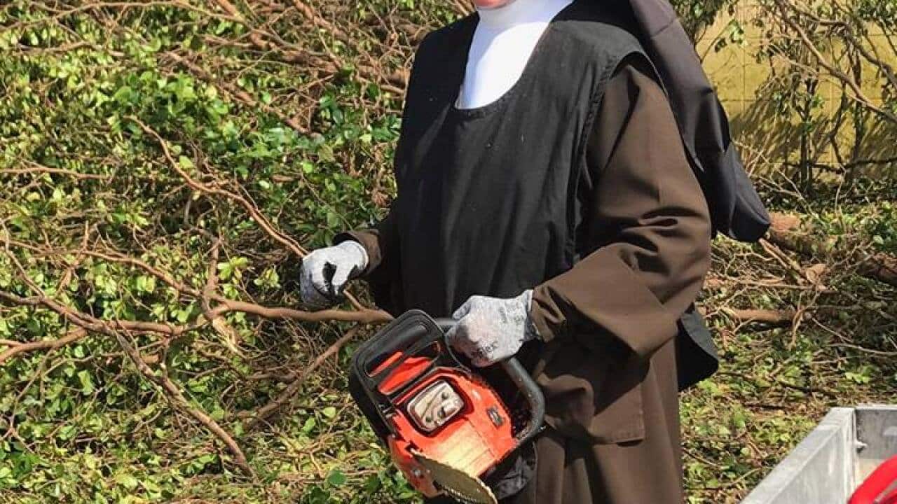 A chainsaw-wielding nun has been filmed cleaning up the debris in Hurricane Irma.