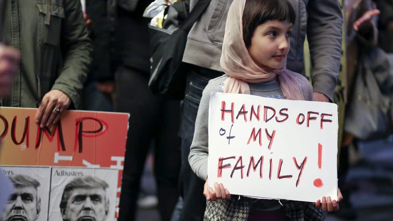 Rosalie Gurna, nine, joins hundreds of protesters in LA denouncing the travel ban from Muslim-majority countries enacted by US President Donald Trump