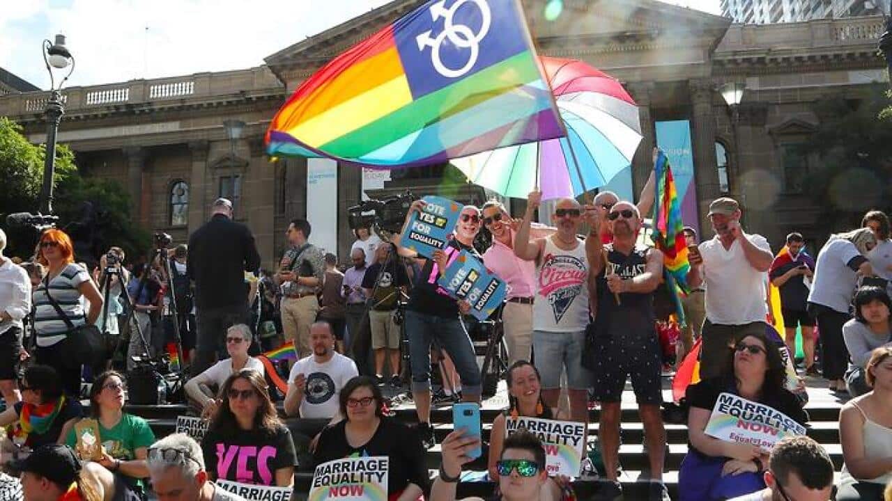 People in front of the State library of Victoria in Melbourne celebrate the outcome of the Same Sex Marriage vote.