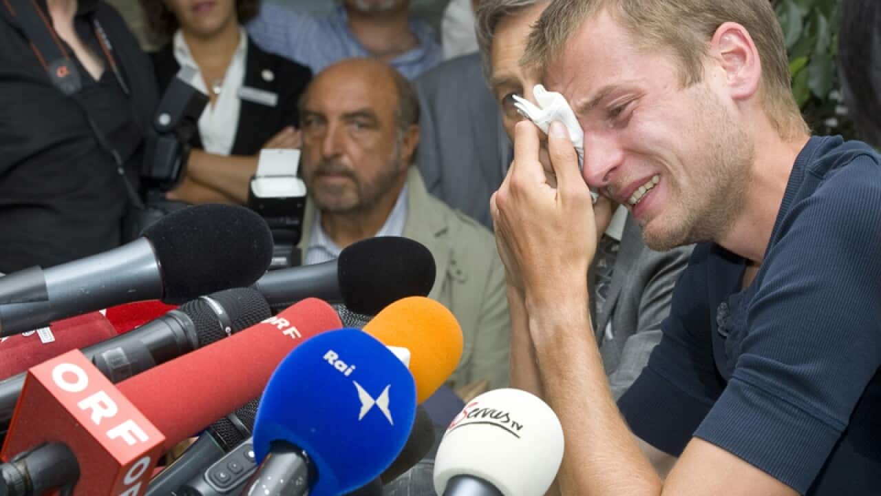 Italy's Alex Schwazer cries as he attends a press conference
