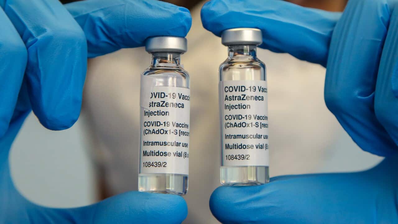 A NHS staff member wearing a face mask holds bottles containing Oxford AstraZeneca Covid-19 vaccine. (Photo by Dinendra Haria / SOPA Images/Sipa USA)