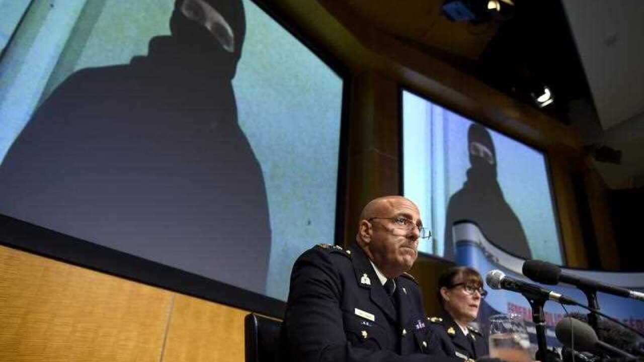 Video footage showing Aaron Driver is seen behind Royal Canadian Mounted Police (RCMP) Deputy Commissioner Mike Cabana