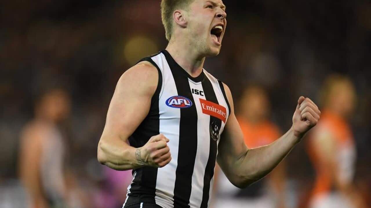 Jordan de Goey of the Magpies reacts after kicking a goal